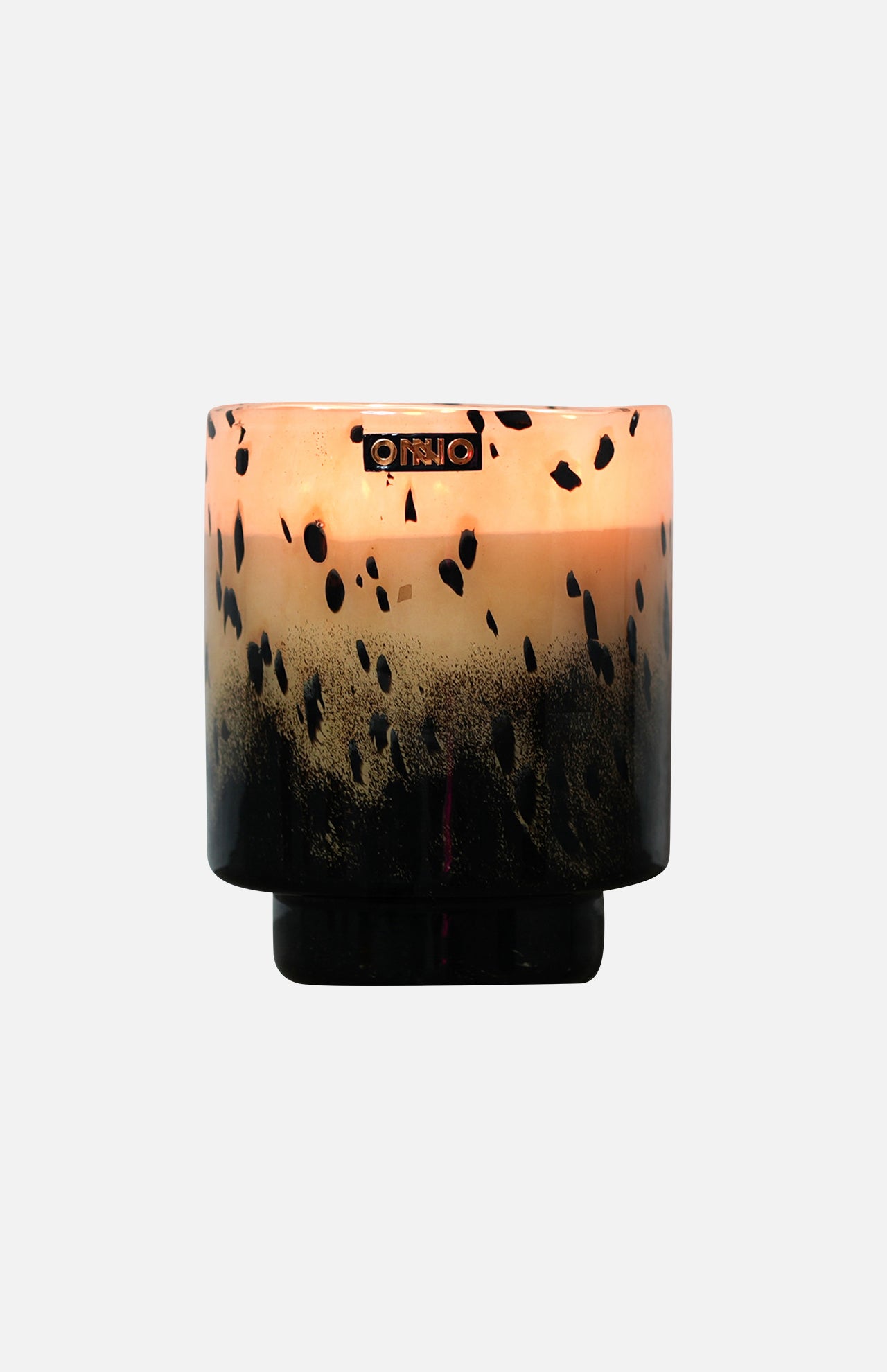 The ONNO Art Brigitte M Zanzibar Candle holder features a round, designer gradient design fading from light peach to black with black speckles and a metallic logo near the rim—ideal for displaying your luxury scented candle.