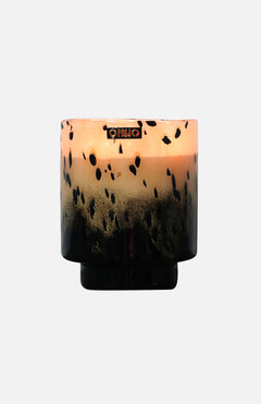 The ONNO Art Brigitte M Zanzibar Candle holder features a round, designer gradient design fading from light peach to black with black speckles and a metallic logo near the rim—ideal for displaying your luxury scented candle.