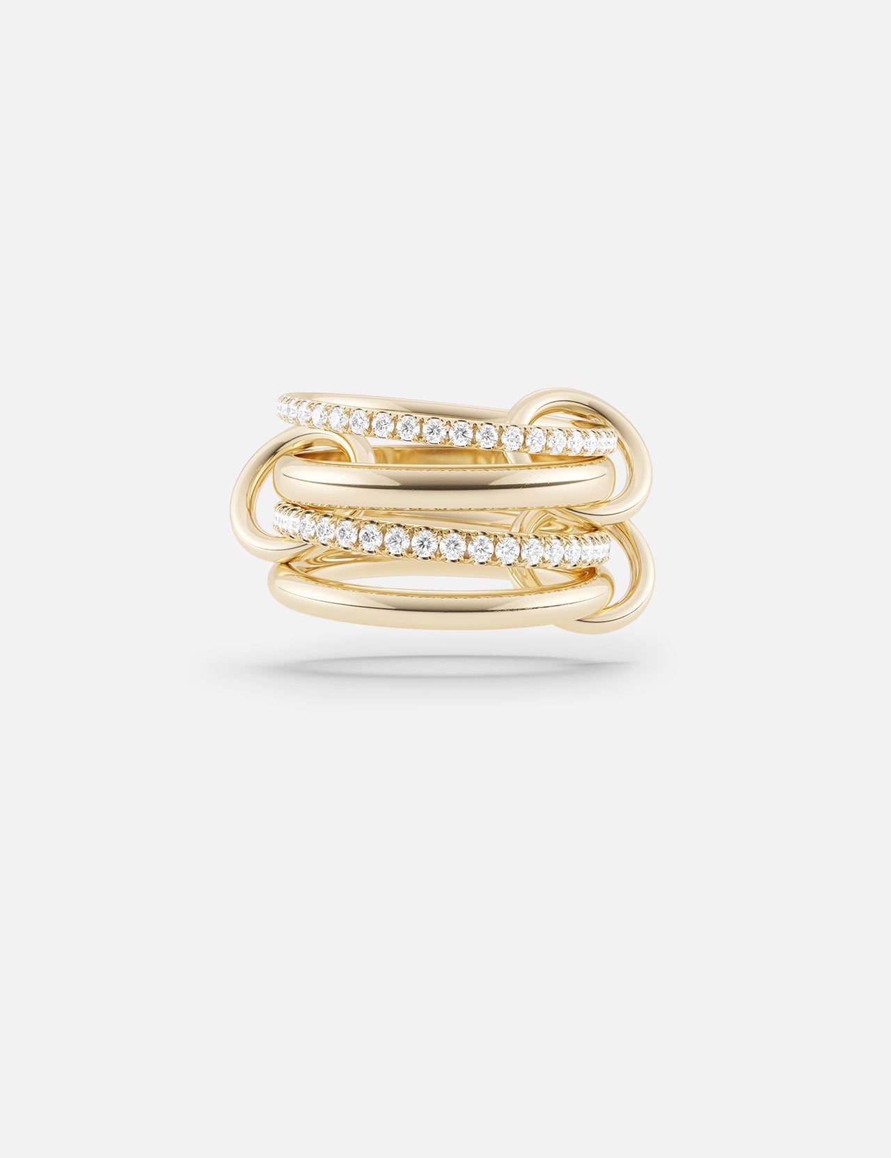 The Polaris 4 Band Ring by SPINELLI KILCOLLIN showcases four intertwined yellow gold bands, two accented with sparkling white gemstones, reflecting the brand's signature style and presented on a plain white background.