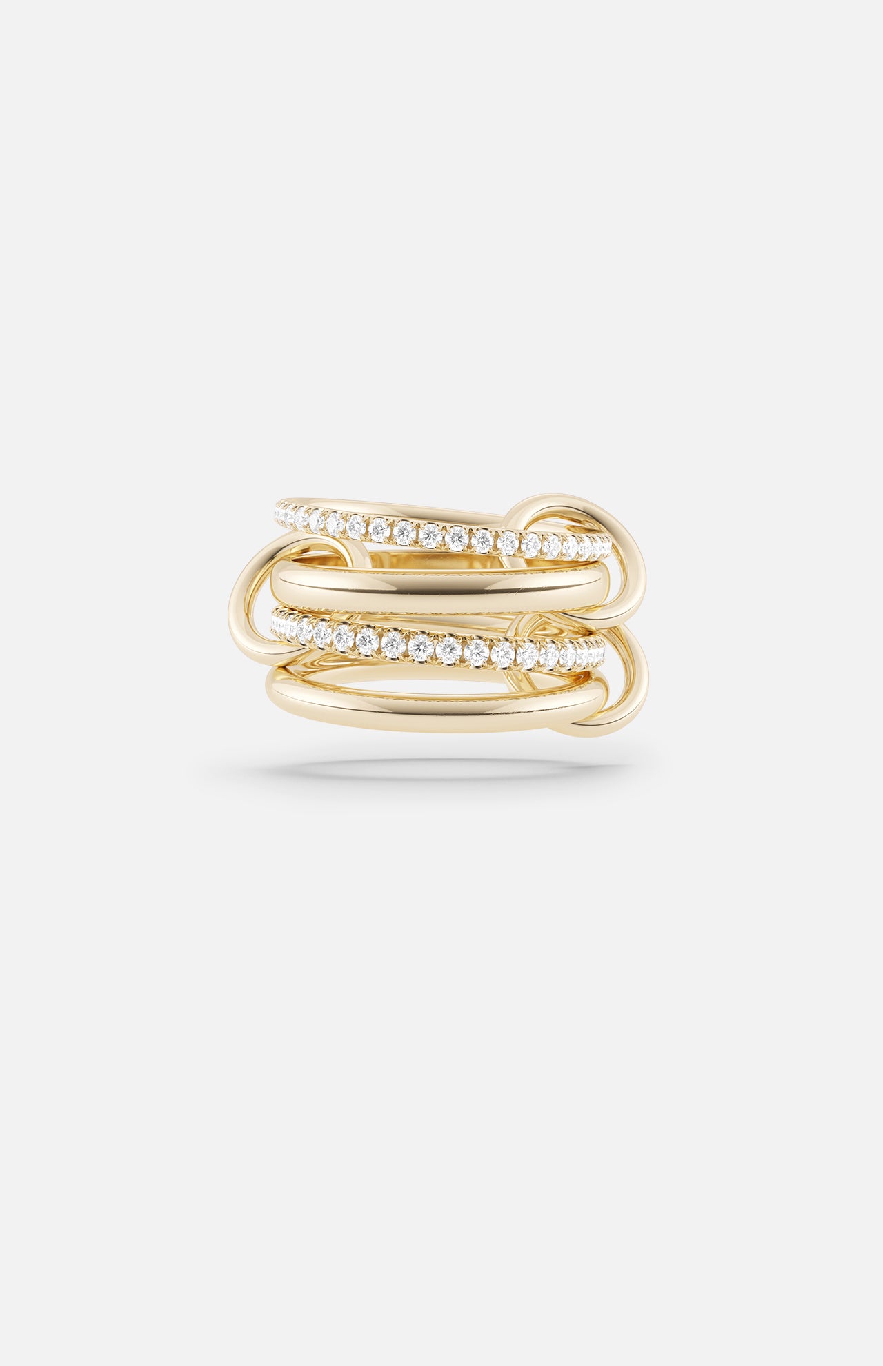 The Polaris 4 Band Ring by SPINELLI KILCOLLIN showcases four intertwined yellow gold bands, two accented with sparkling white gemstones, reflecting the brand's signature style and presented on a plain white background.