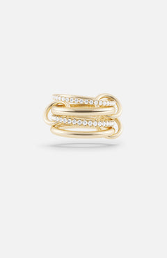 The Polaris 4 Band Ring by SPINELLI KILCOLLIN showcases four intertwined yellow gold bands, two accented with sparkling white gemstones, reflecting the brand's signature style and presented on a plain white background.