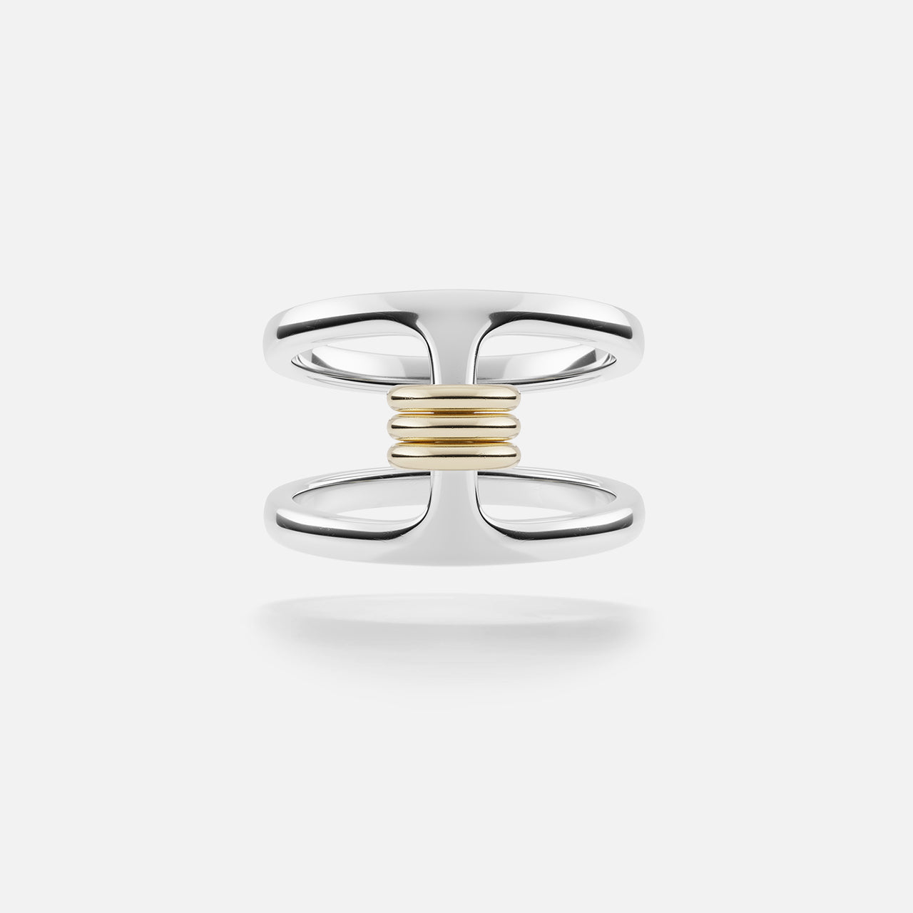 The Phantom SK Ring by SPINELLI KILCOLLIN features a sterling silver open double-band joined at the center with a horizontal row of yellow gold annulets, set against a plain white background.