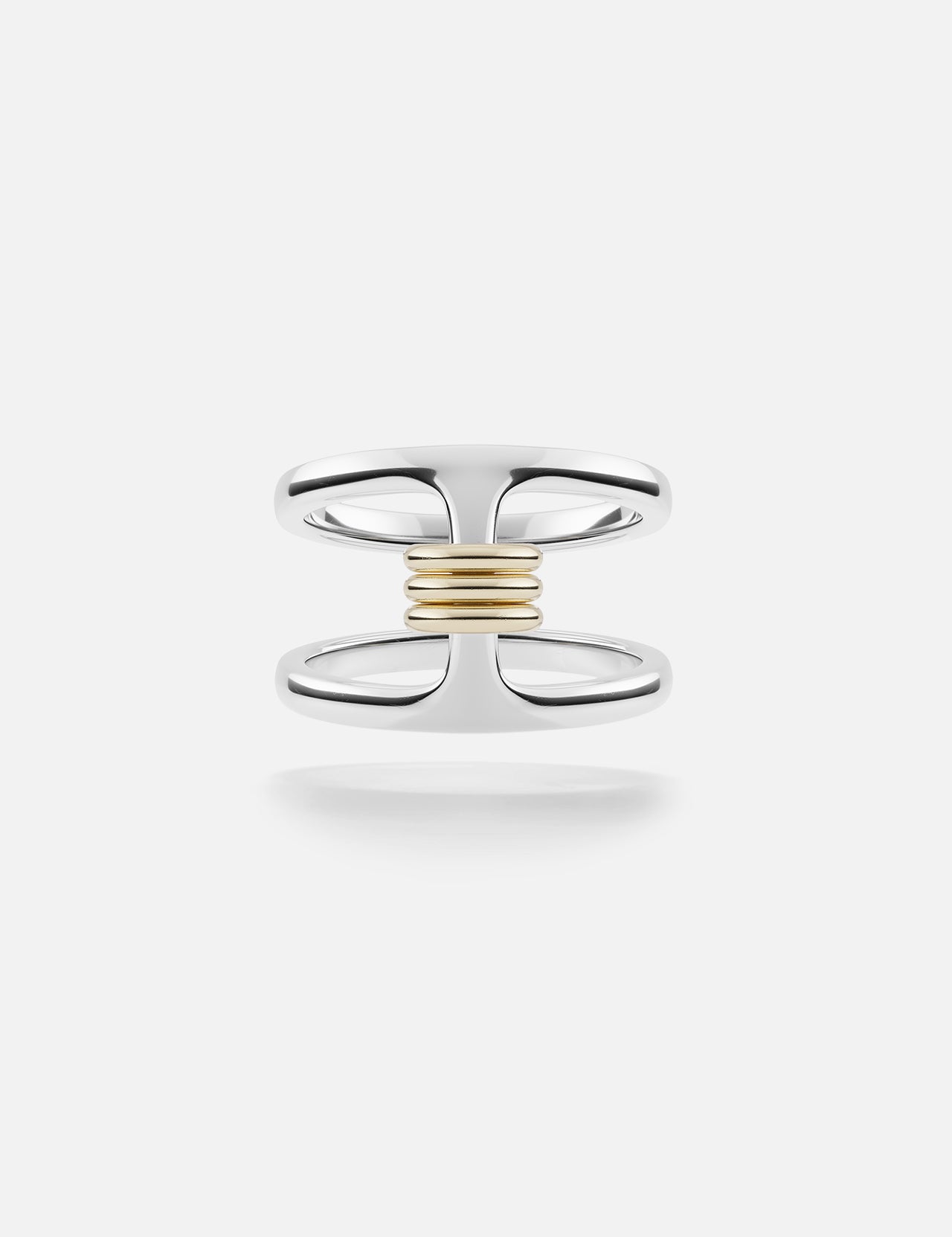 The Phantom SK Ring by SPINELLI KILCOLLIN features a sterling silver open double-band joined at the center with a horizontal row of yellow gold annulets, set against a plain white background.