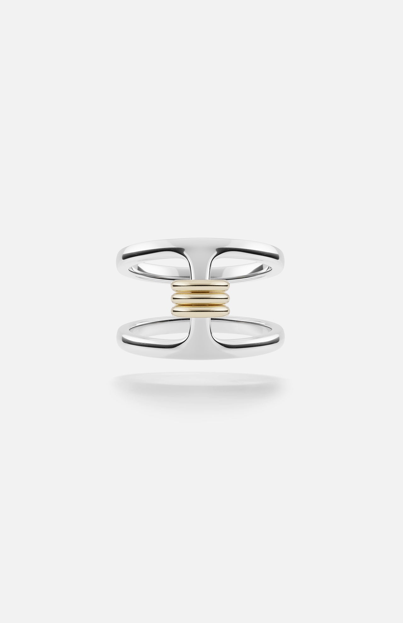 The Phantom SK Ring by SPINELLI KILCOLLIN features a sterling silver open double-band joined at the center with a horizontal row of yellow gold annulets, set against a plain white background.