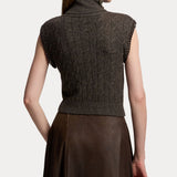 A woman is shown from the back against a plain white background, wearing the RALPH LAUREN COLLECTION Cashmere Turtleneck Sleeveless Sweater in dark gray paired with a brown skirt.