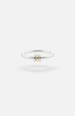 The SPINELLI KILCOLLIN Sirius 3 Annulets Ring is a minimalist unisex sterling silver band featuring two silver beads flanking a gold bead, set against a plain white background—perfect for modular jewelry styling.