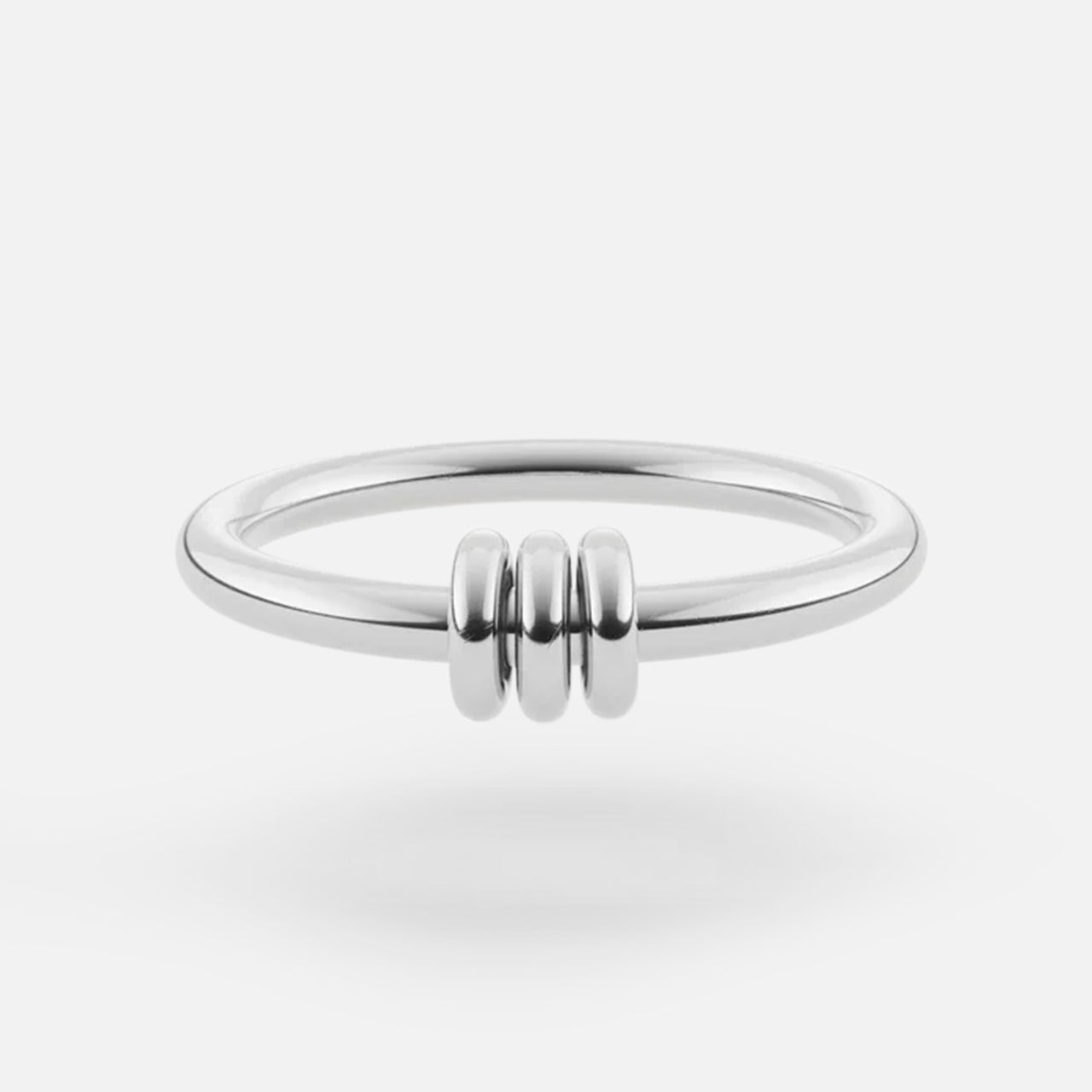 The SPINELLI KILCOLLIN Sirius 3 Annulets Ring is a minimalist unisex sterling silver ring with three small rounded beads at the center, shown on a white background.