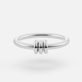 The SPINELLI KILCOLLIN Sirius 3 Annulets Ring is a minimalist unisex sterling silver ring with three small rounded beads at the center, shown on a white background.