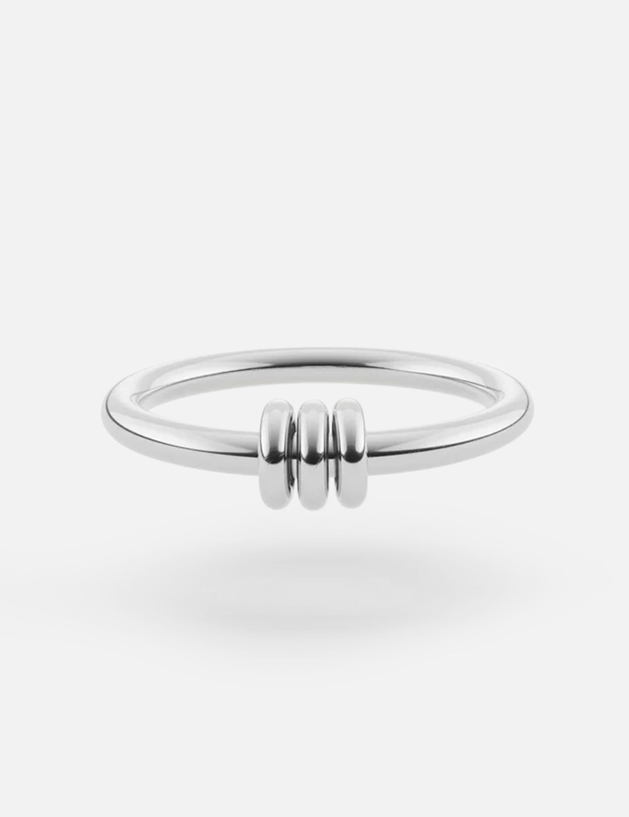 The SPINELLI KILCOLLIN Sirius 3 Annulets Ring is a minimalist unisex sterling silver ring with three small rounded beads at the center, shown on a white background.