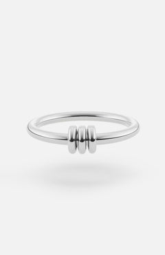 The SPINELLI KILCOLLIN Sirius 3 Annulets Ring is a minimalist unisex sterling silver ring with three small rounded beads at the center, shown on a white background.