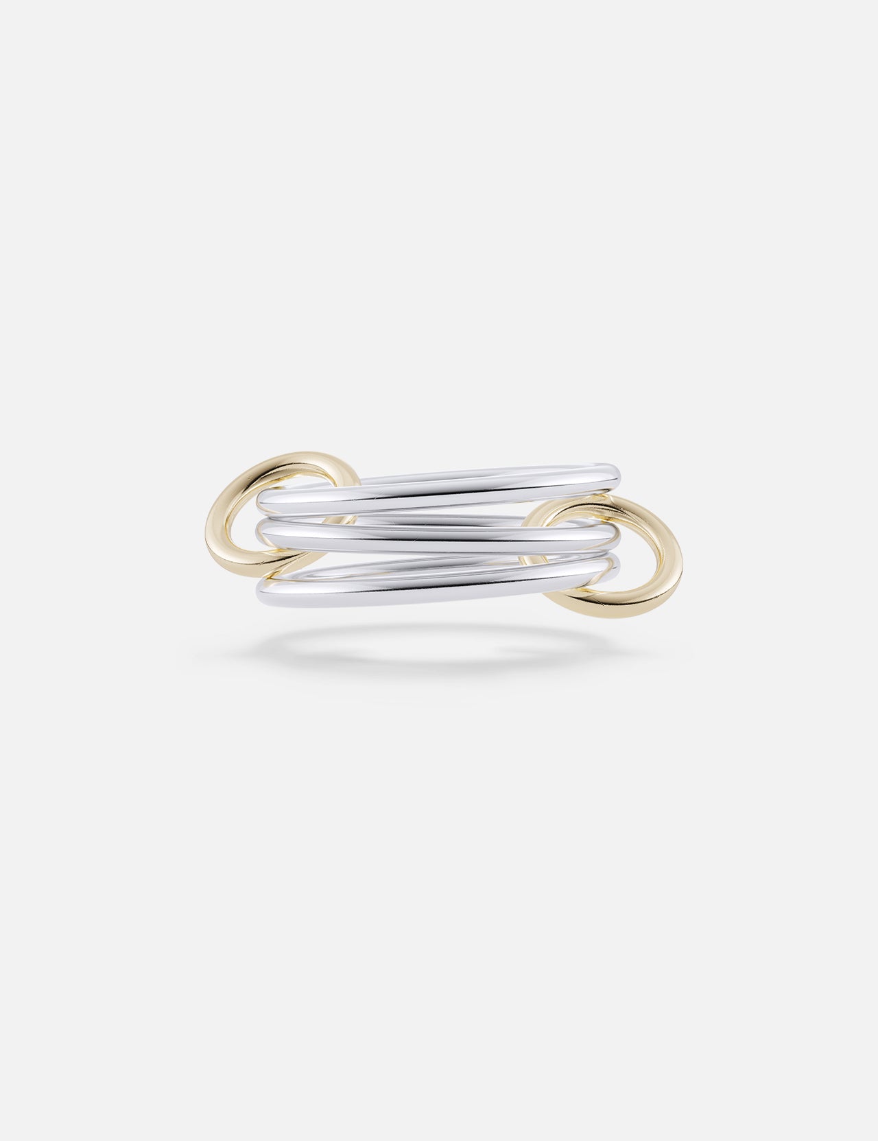 The Solarium SG 3 Band Ring by SPINELLI KILCOLLIN features modern intertwining sterling silver bands with yellow gold connectors, showcasing elegant, overlapping minimalism against a plain white background.