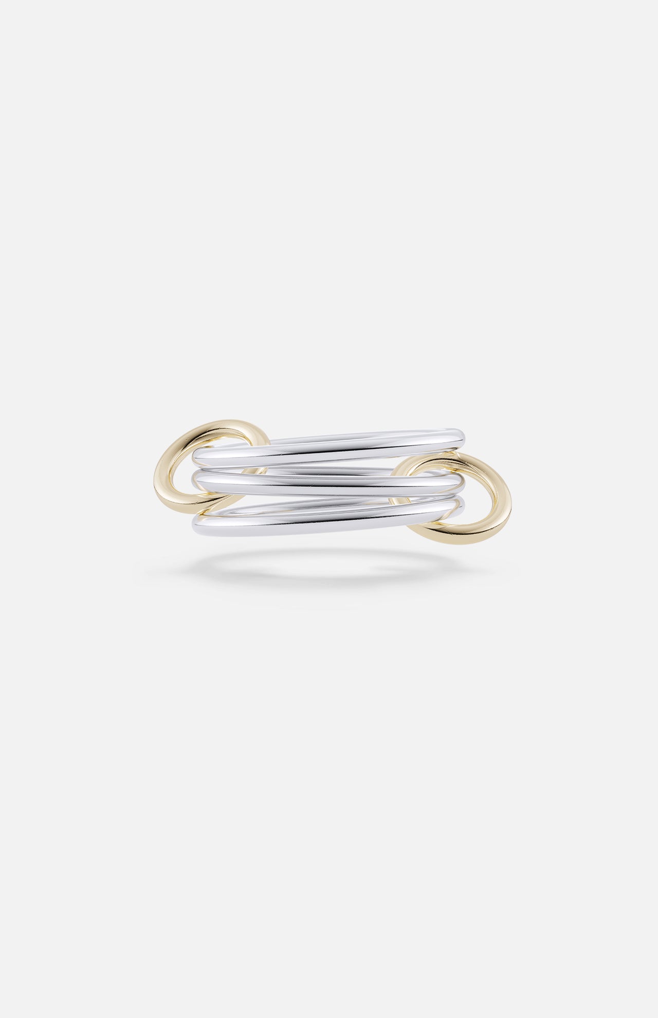 The Solarium SG 3 Band Ring by SPINELLI KILCOLLIN features modern intertwining sterling silver bands with yellow gold connectors, showcasing elegant, overlapping minimalism against a plain white background.