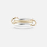 The Solarium 3 Band Ring by SPINELLI KILCOLLIN features interwoven sterling silver and yellow gold loops in a minimalist, elegant design, showcased against a plain white background.