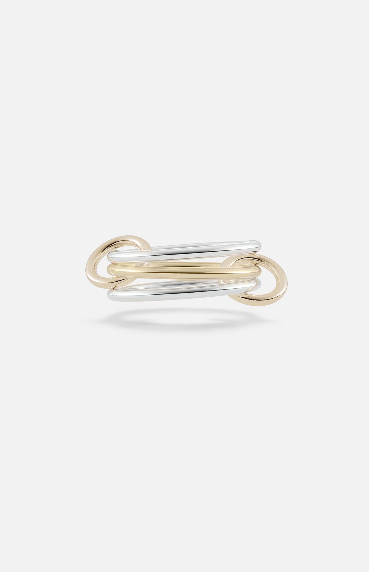 The Solarium 3 Band Ring by SPINELLI KILCOLLIN features interwoven sterling silver and yellow gold loops in a minimalist, elegant design, showcased against a plain white background.
