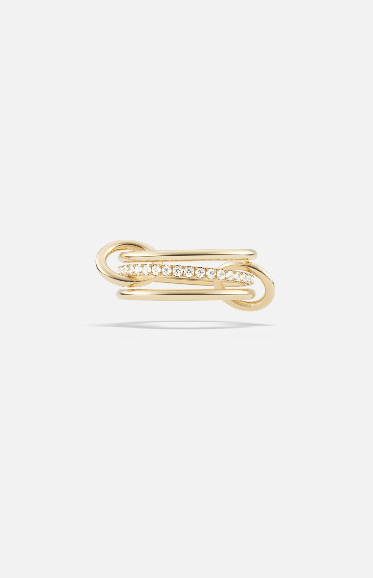 The SPINELLI KILCOLLIN Sonny Pavé Band Ring showcases an elegant looping yellow gold design with a row of sparkling pavé diamonds set at the center, displayed against a plain white background.