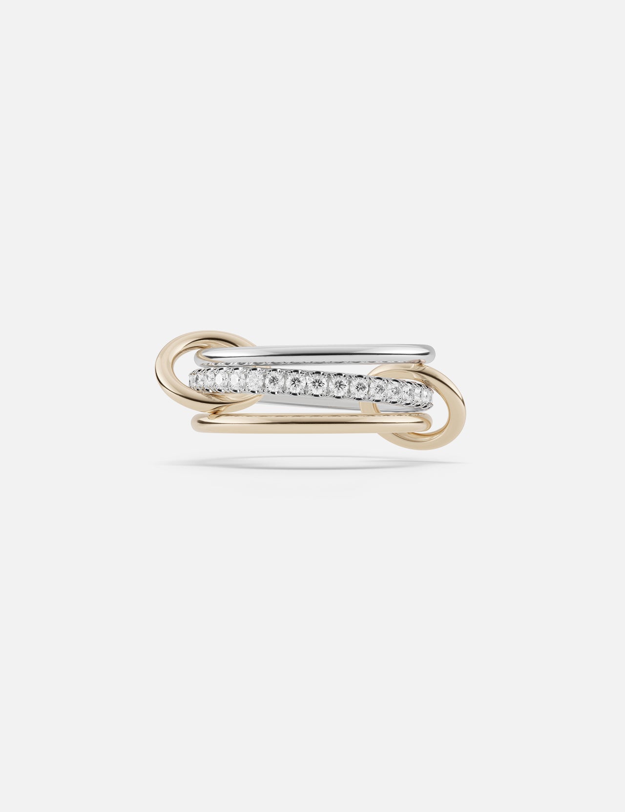 The SPINELLI KILCOLLIN Tigris Pavé Band Ring features intertwined yellow and white gold bands, with the white gold band pavé-set with round diamonds, showcased against a plain white background.
