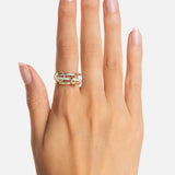 A hand with neatly manicured nails wears the SPINELLI KILCOLLIN Tigris Pavé Band Ring, showcasing its unique modular design on the middle finger against a plain white background.