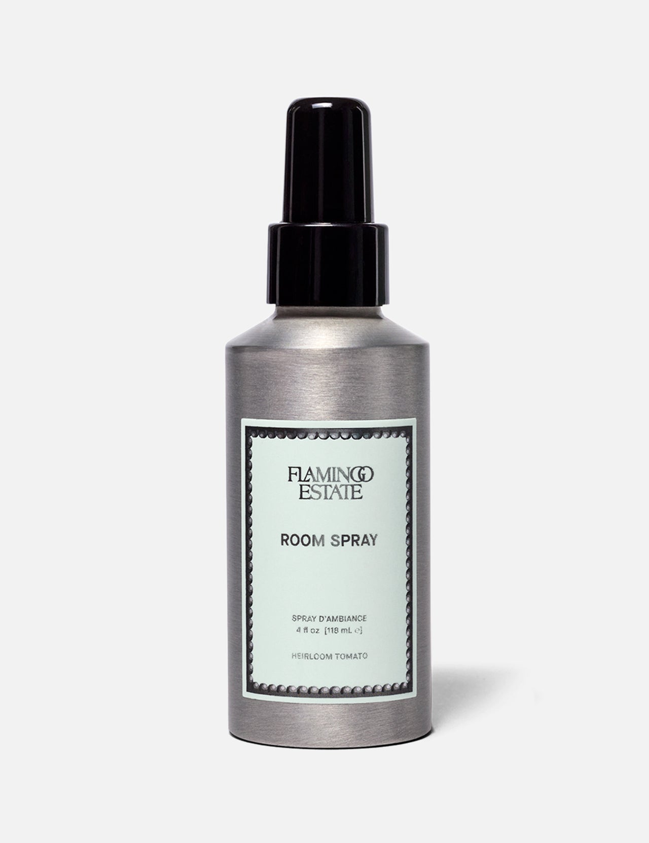 A silver bottle of FLAMINGO ESTATE Roma Heirloom Tomato Room Spray, adorned with a mint green label and black spray nozzle, set against a simple light background—this home fragrance evokes the fresh scent of summer-ripe tomatoes at their peak.