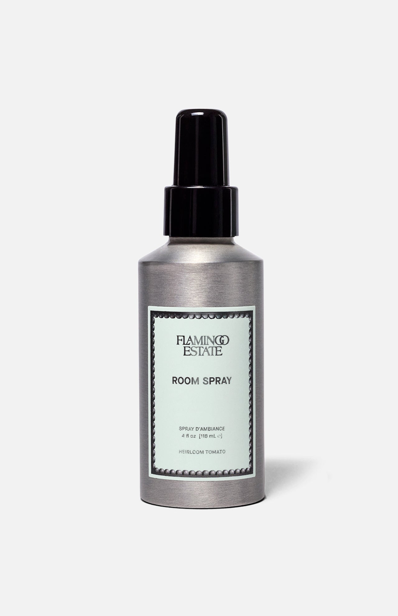 A silver bottle of FLAMINGO ESTATE Roma Heirloom Tomato Room Spray, adorned with a mint green label and black spray nozzle, set against a simple light background—this home fragrance evokes the fresh scent of summer-ripe tomatoes at their peak.