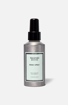 A silver bottle of FLAMINGO ESTATE Roma Heirloom Tomato Room Spray, adorned with a mint green label and black spray nozzle, set against a simple light background—this home fragrance evokes the fresh scent of summer-ripe tomatoes at their peak.