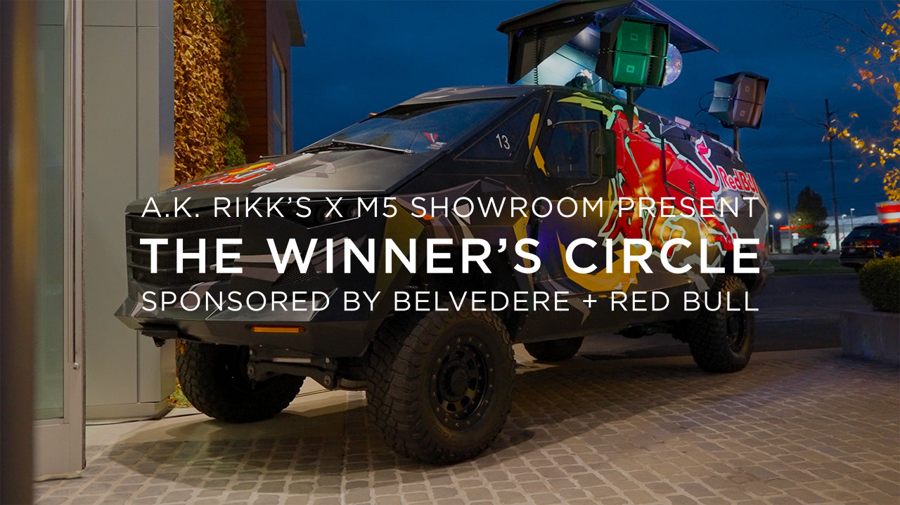 image with text "A.K. Rikk's X M5 Showroom Present The Winner's Circle Sponsored by Belvedere and Red Bull" image is of a Red Bull brand wrapped vehicle and dj booth 