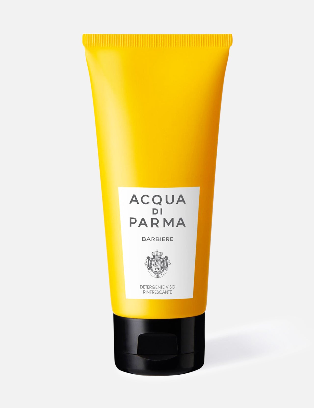 A yellow tube of ACQUA DI PARMA Barbiere Refreshing Face Wash with a black cap and white label stands upright against a white background. Made in Italy, it’s perfect for an elevated grooming routine.