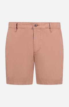 The AG Cipher Short in light pink features a slim fit, belt loops, side pockets, and a front button and zipper closure, shown against a white background.