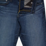 The Everett Jean in 5 Years by AG features dark blue denim with a partially open front zipper, showcasing the inside lining, front pockets, button closure, straight legs, and visible stitching.