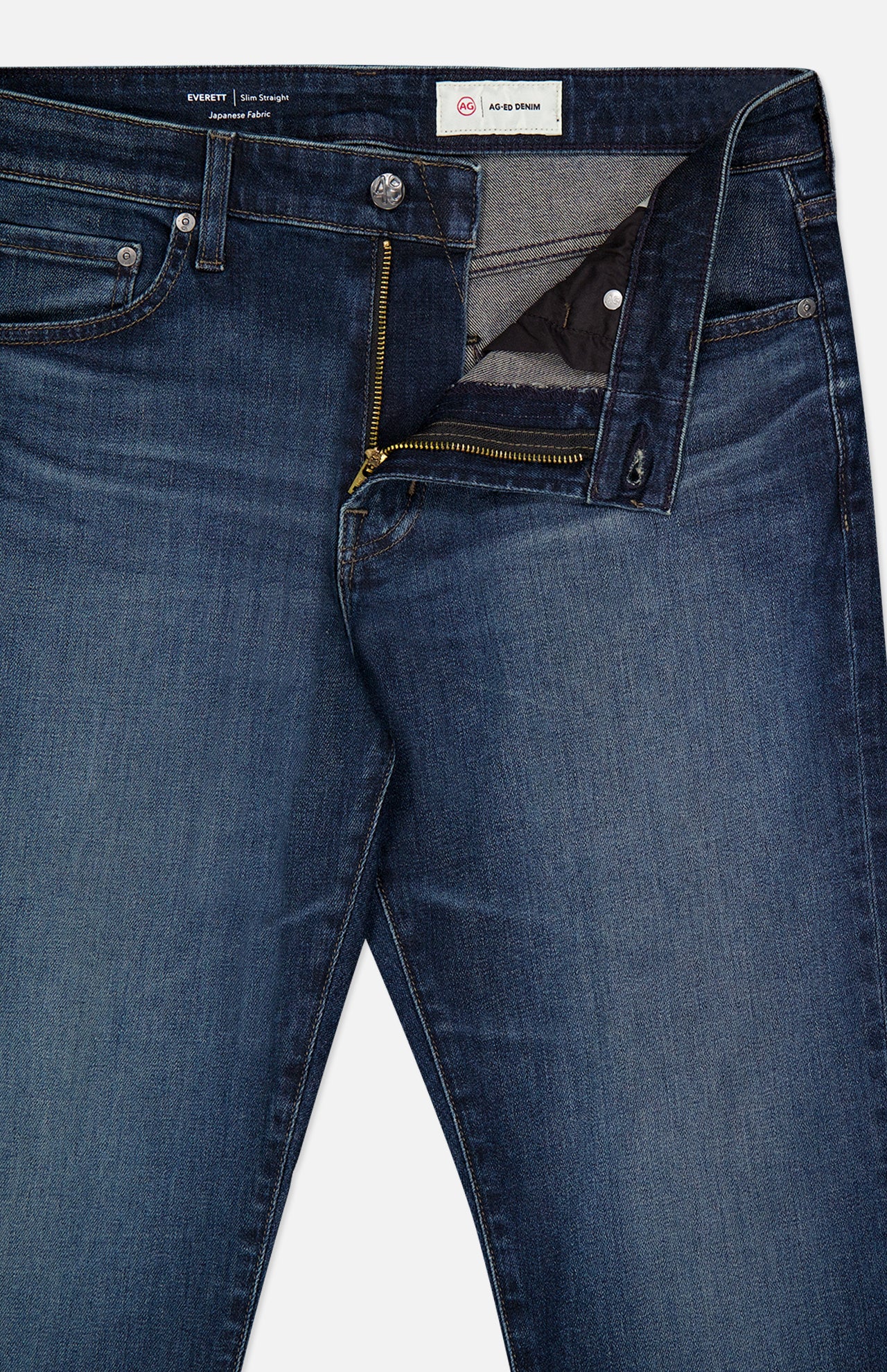 The Everett Jean in 5 Years by AG features dark blue denim with a partially open front zipper, showcasing the inside lining, front pockets, button closure, straight legs, and visible stitching.