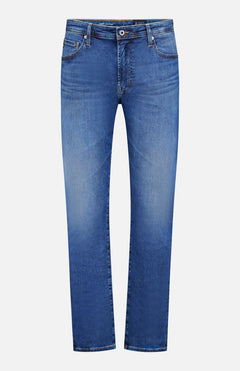 The AG Cloud Soft Everett Jeans in Grove feature a classic dark blue wash, straight-leg cut, five pockets, belt loops, and a button-zipper closure, shown against a white background.