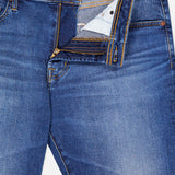A close-up of the AG Cloud Soft Everett Jeans in Grove, featuring dark blue denim in a slim fit with a partially open zipper and button fly, showcasing the inner lining and detailed stitching.