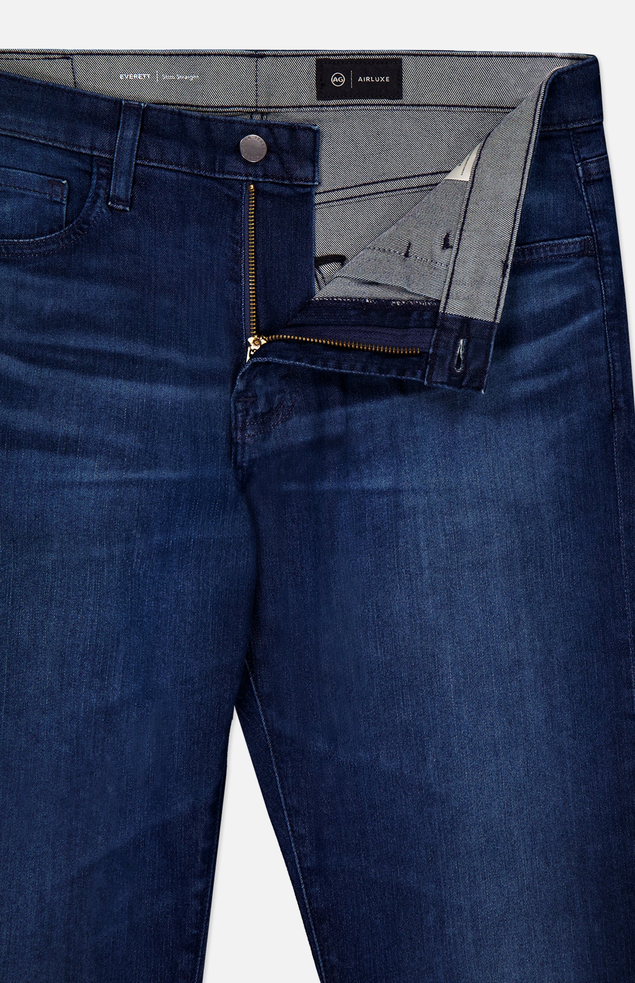 The AG Everett Jeans in Yountville are slim straight, ultra-dark blue denim with slight thigh fading and an open waistband showing the interior lining. Made from Airluxe material for comfort and a modern look.