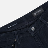 Close-up of the waistband and upper front section of the AG Everett Slim Corduroy Pant in dark navy, highlighting the buttons, pockets, belt loops, and an interior label displaying “LOS ANGELES” and “EVERETT Slim Straight.” This classic straight-leg design from AG lends a modern edge to your everyday style.