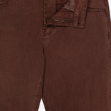 Close-up of AG’s Everett Pants in Sulfur, brown denim with the zipper and button undone, revealing the waistband and inside tag marked 32x32 slim fit.