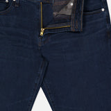 Graduate Pant in Studio by AG, showcasing an ultra-dark blue wash with vintage-inspired details, brass zipper, and white button fly—partially unzipped and unbuttoned to reveal the waistband and inner pocket lining—displayed against a plain background.