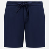 The AG Oliver Drawstring Shorts feature a mid-rise fit, elastic waistband with drawstring, front pockets, and a minimalist navy design, shown against a plain white background.