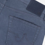 Close-up of the back of AG Tellis Sueded Sateen Pants in Blue Grain, showing a single back pocket with decorative stitching and a dark rectangular patch on the waistband.