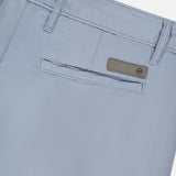 Close-up of the back pocket of AG Wanderer 8.5" Inseam Shorts in light blue, featuring a horizontal slit pocket, belt loops, and a small rectangular label above the pocket.