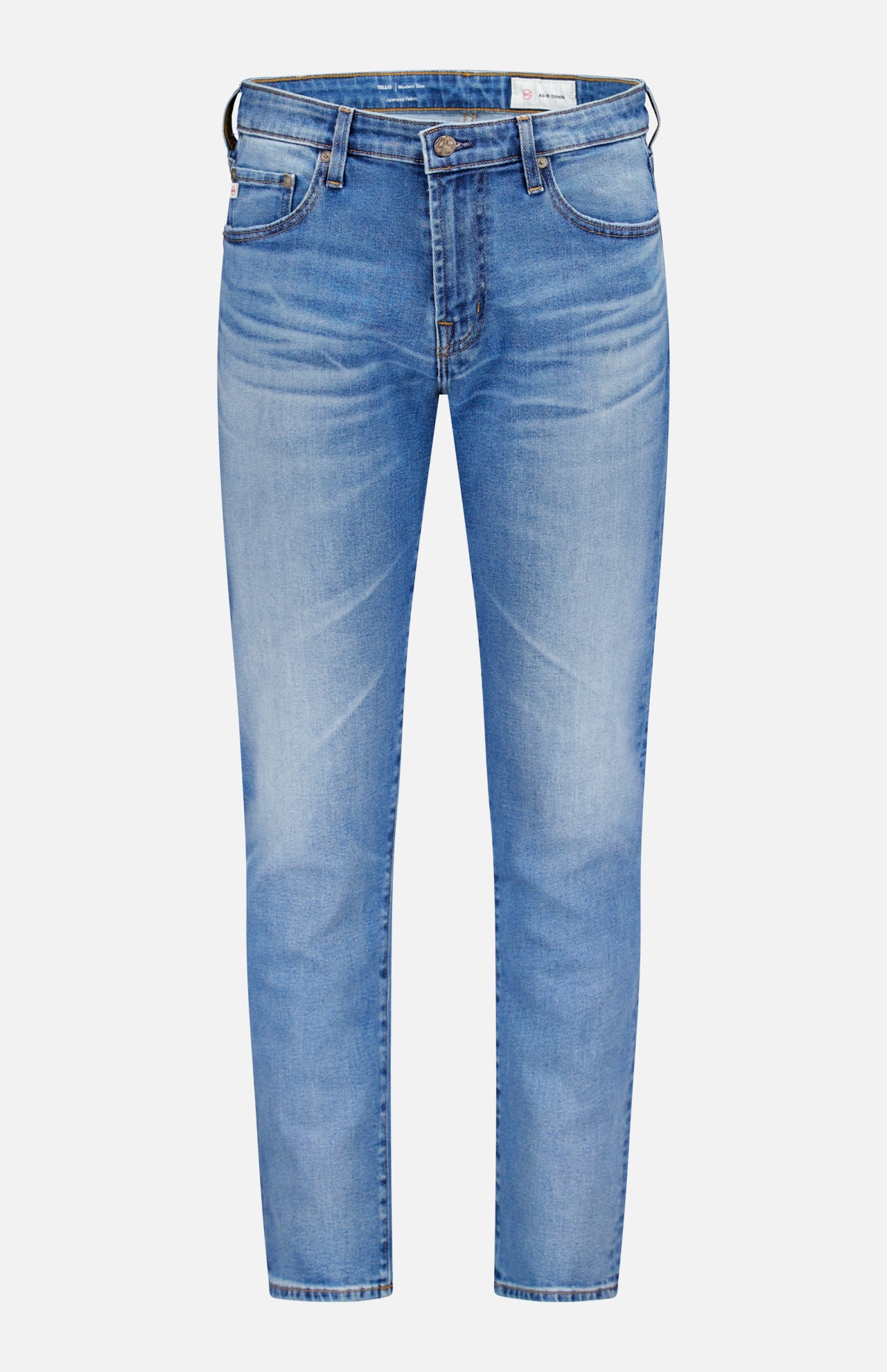 The AG Tellis Aged Jeans are slim-fit, light blue denim with a classic five-pocket design and button closure, shown against a plain white background.