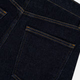 Close-up of the back pocket and stitching detail on the AGOLDE Harper Jean in Reissue, featuring one pocket and part of another with yellow thread. The straight leg dark indigo denim showcases classic construction and quality craftsmanship.