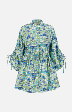 The Pam Floral Mini Dress by ALEMAIS features a blue and green micro floral print, long puffed sleeves with adjustable ties, a collared neckline, and a drawstring waist for a flattering, comfortable fit.