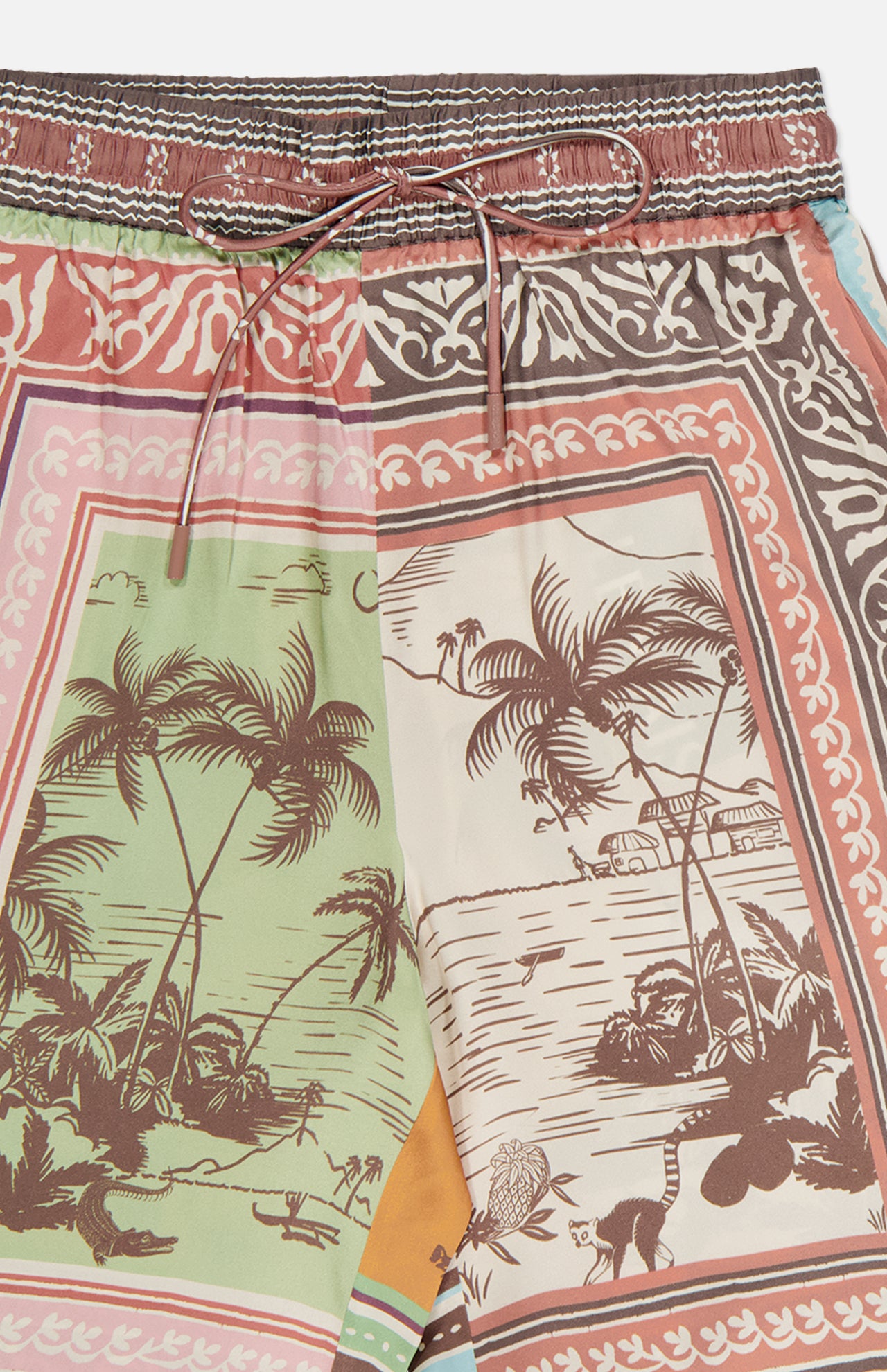 The ALEMAIS Alberta Silk Pull-on Pant features a relaxed fit and tropical patterns with palm trees, animals, and coastal scenery in earthy green, brown, red, and cream tones for a bohemian look.