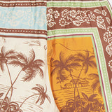 The ALEMAIS Alberta Silk Pull-on Pant features colorful, tropical island-inspired patterns with floral designs in earthy tones and vibrant blues, creating a bohemian vibe on these relaxed-fit pants.