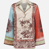 The ALEMAIS Alberta Silk Relaxed-fit Shirt features long sleeves, a notched collar, and a bohemian tropical landscape print in brown, cream, blue, red, and green. Intricate borders and the brand label at the neck make it ideal resort wear.