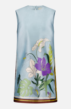 The Alfie Floral Mini Dress by ALEMAIS is a sleeveless pale blue silk mini dress with purple, white, and yellow florals, green leaves, and a striped border on the hem and sides for a fresh shift silhouette.