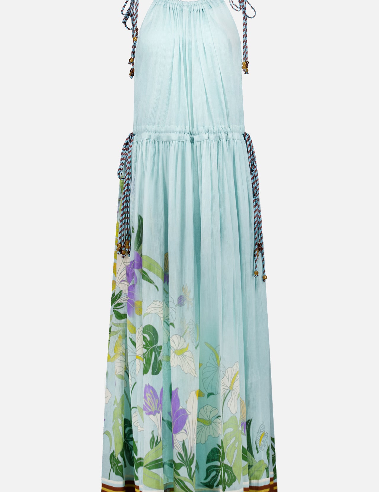 The Alfie Sleeveless Midi Dress by ALEMAIS is a light blue cotton dress with drawstring ties at the shoulders and waist, a floral-print hem in green, purple, and white, and brown-and-white striped trim at the bottom.