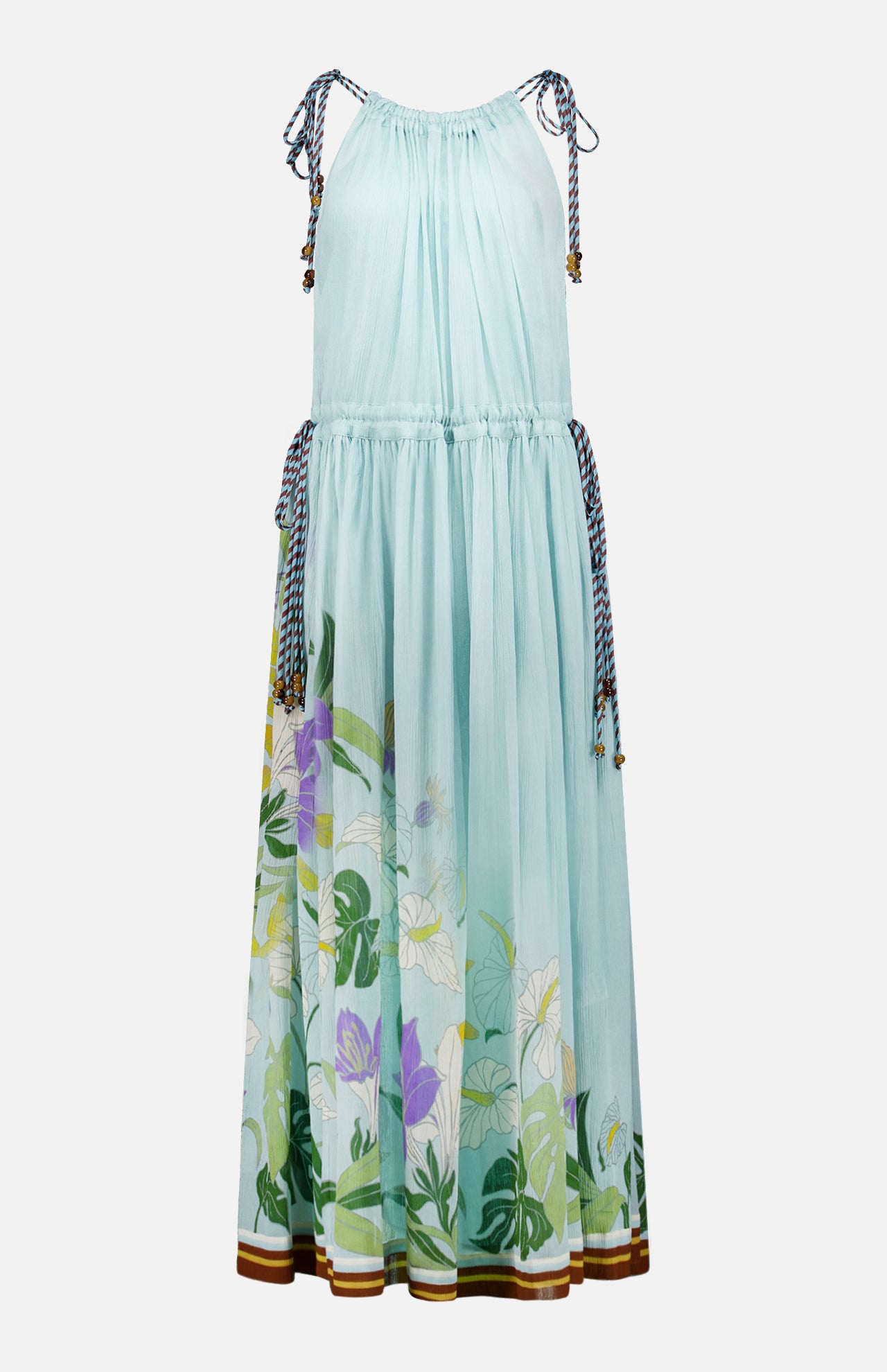 The Alfie Sleeveless Midi Dress by ALEMAIS is a light blue cotton dress with drawstring ties at the shoulders and waist, a floral-print hem in green, purple, and white, and brown-and-white striped trim at the bottom.
