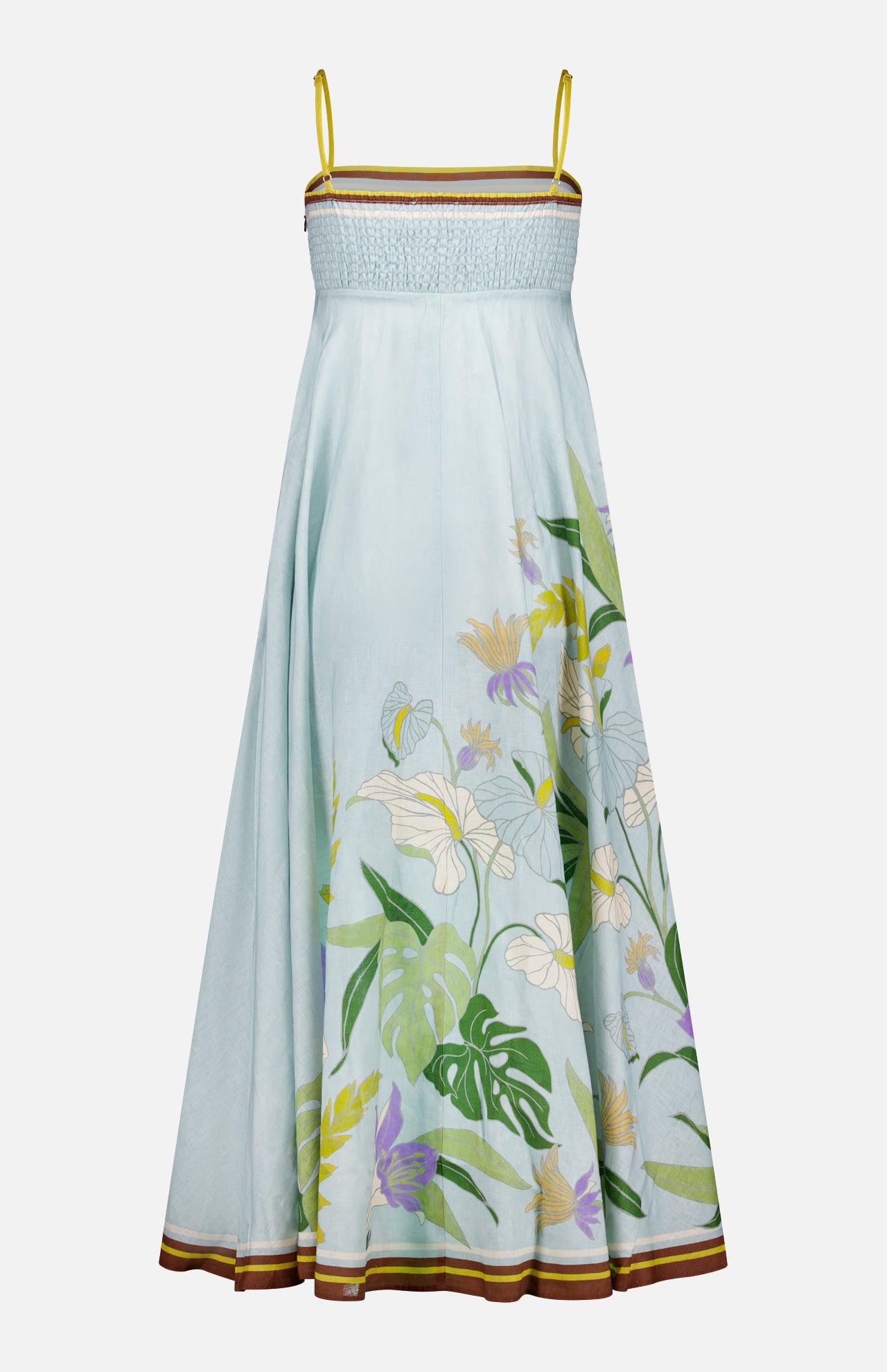 The Alfie Midi Floral Sundress by ALEMAIS features a pale blue linen design with yellow spaghetti straps, smocked bodice, and a flared skirt accented by green, white, and purple tropical floral prints—perfect for sunny days.