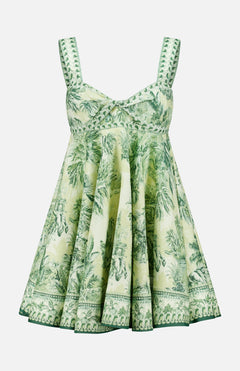 The ALEMAIS Sara Mini Twist Sundress is a sleeveless, flared green and white mini dress with a tropical palm print and decorative green stitching—perfect for sunny days.
