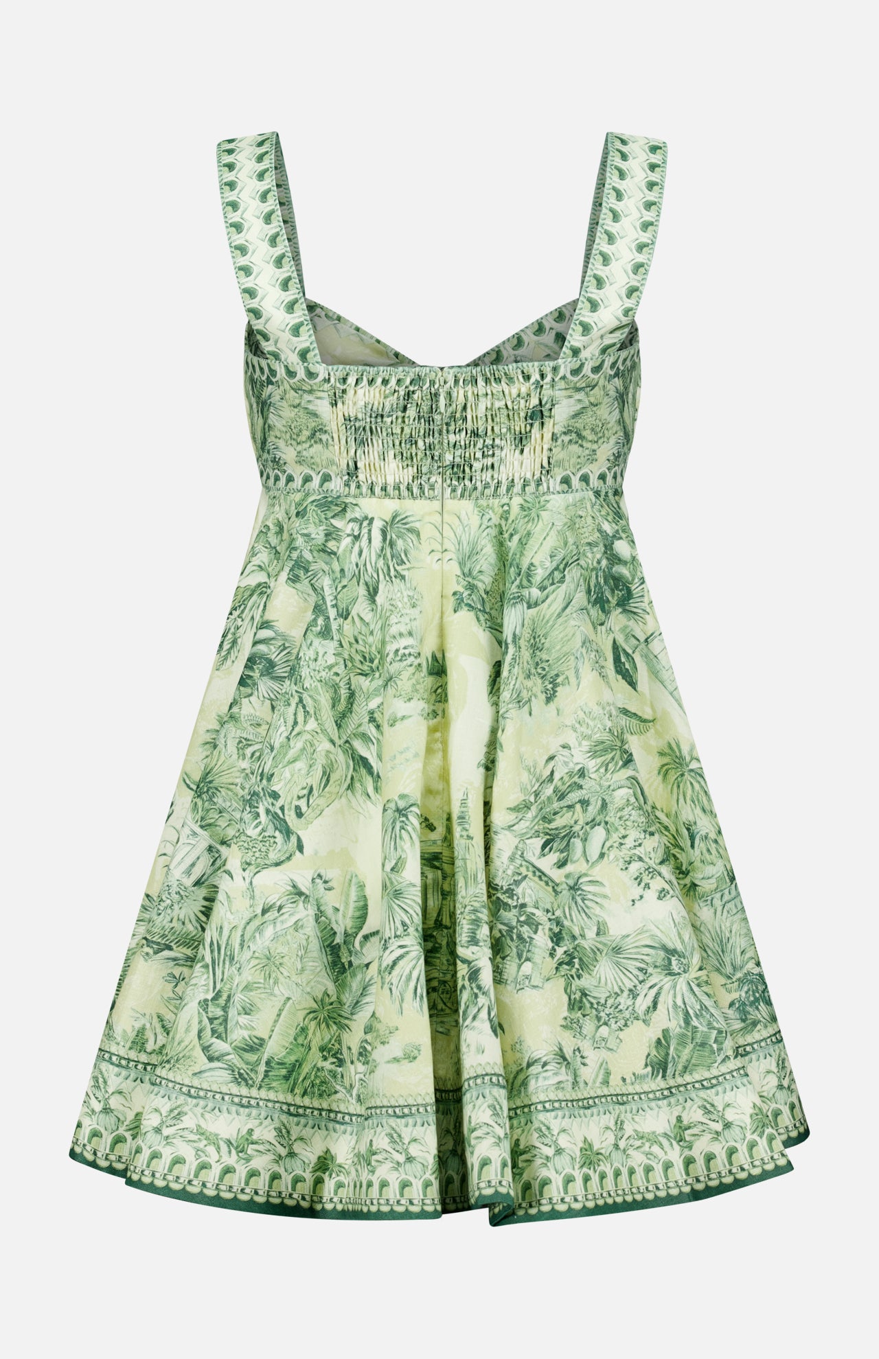 The Sara Mini Twist Sundress by ALEMAIS is a green and white flared mini dress with wide straps, a smocked bodice, and a tropical palm print—perfect for sunny days.